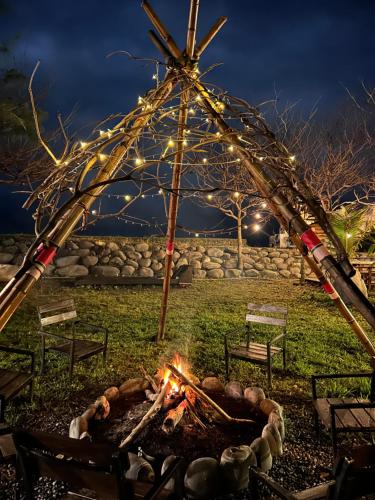 a fire pit in a park at night with lights at Bridge12th B&B in Yanliau