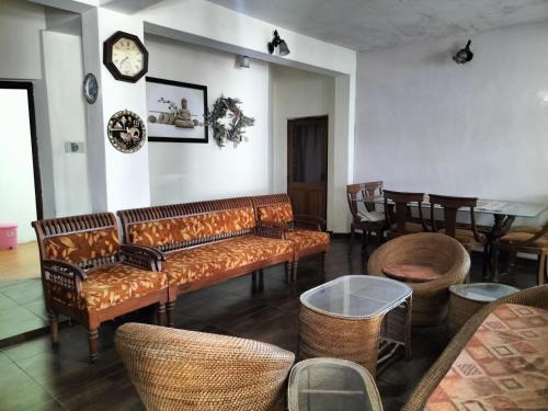 a living room with a couch and chairs and a table at kailwood Guest House in McLeod Ganj