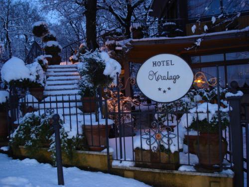 a hotel welcome sign on a fence in the snow at Miralago in Albano Laziale