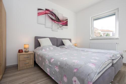 a bedroom with a large bed and a window at Apartment Kristina by EL-PI Tours in Županje