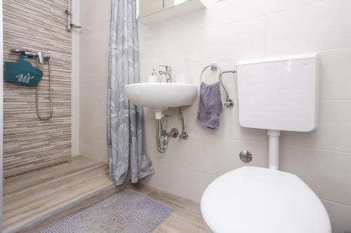 a bathroom with a toilet and a sink and a shower at Apartment Kristina by EL-PI Tours in Županje