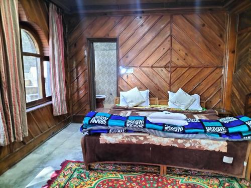 a bedroom with two beds in a wooden room at kailwood Guest House in McLeod Ganj
