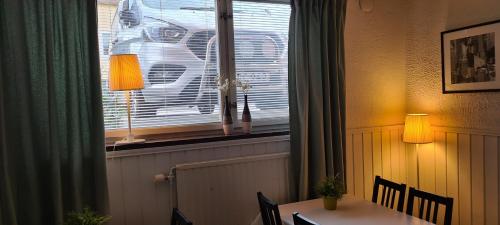 a dining room with a table and a window at Lilla Hotellet in Eskilstuna