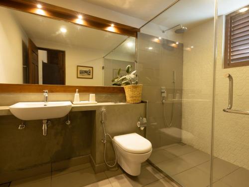 a bathroom with a toilet and a sink and a shower at Edgar Mansion Kandy in Kandy
