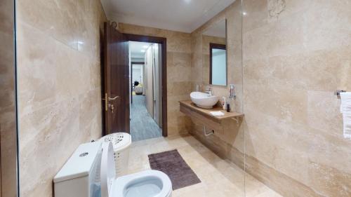 a bathroom with a sink and a toilet and a shower at Central Valletta - 1 Bedroom maisonnette in Valletta