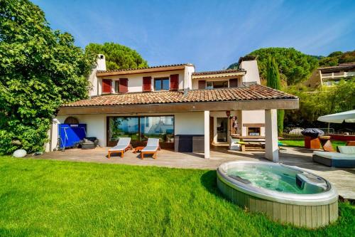 a house with a hot tub in the yard at Sunset House with gorgeous view of the lake in Montreux