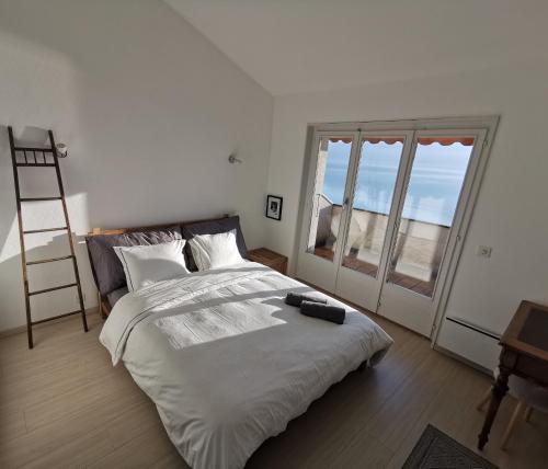 a bedroom with a large bed and a large window at Sunset House with gorgeous view of the lake in Montreux