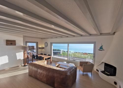 a living room with a couch and a table at Sunset House with gorgeous view of the lake in Montreux