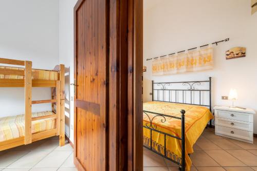 a bedroom with two bunk beds and a hallway at Maya in Villasimius