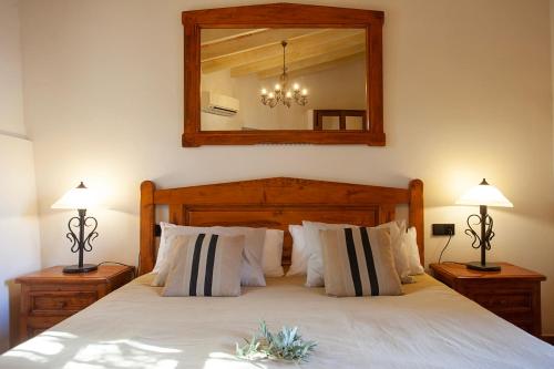 a bedroom with a bed with two lamps and a mirror at S'Hort de Son Caulelles - Adults Only in Marratxí 