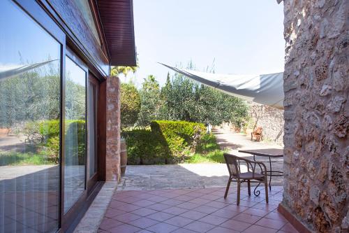 a patio with a table and chairs next to a building at S'Hort de Son Caulelles - Adults Only in Marratxí 