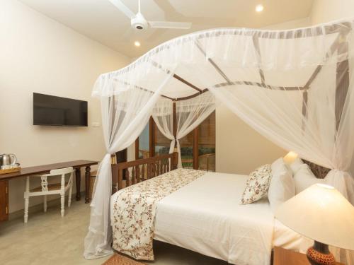 a bedroom with a bed with a canopy at Edgar Mansion Kandy in Kandy