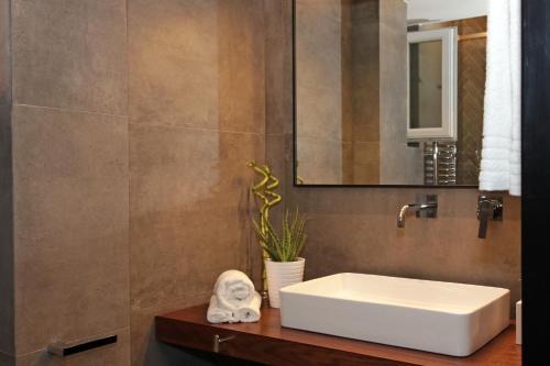 a bathroom with a white sink and a mirror at The 4 Travellers Thessaloniki in Thessaloniki