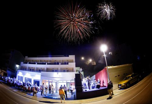 a crowd of people standing in front of a building with fireworks at Villa Palloma in Baška Voda