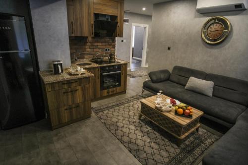 a living room with a couch and a table at Rhisos Gold Otel in Rize