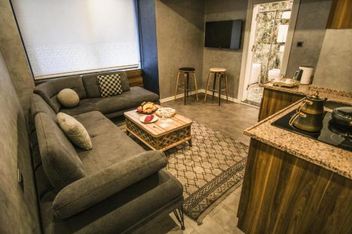 a living room with a couch and a table at Rhisos Gold Otel in Rize