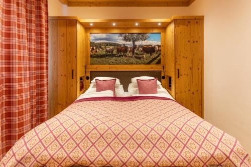 a bedroom with a bed with a painting on the wall at Madlhof in Himmelreich