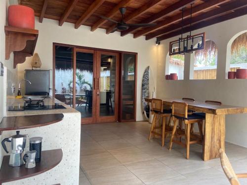 a kitchen with a table and a dining room at La Villa Loca in Gili Air