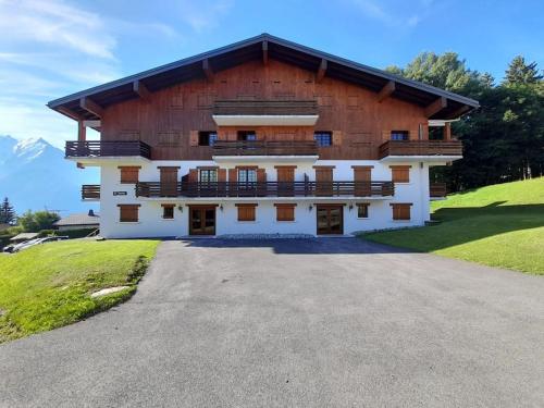 a large wooden building with a lot of windows at Le cocon du Bettex 1400 - Cozy Apt near Mont Blanc in Saint-Gervais-les-Bains