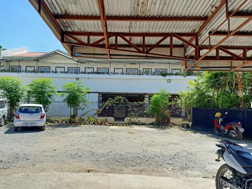 a car parked in a parking lot in front of a building at MB's Garden Inn in Mactan