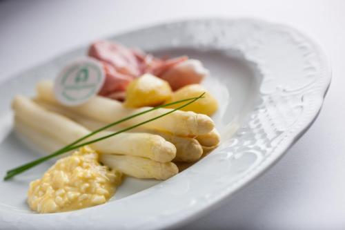 a white plate of food on a white plate at Hotel Sparerhof in Vilpiano