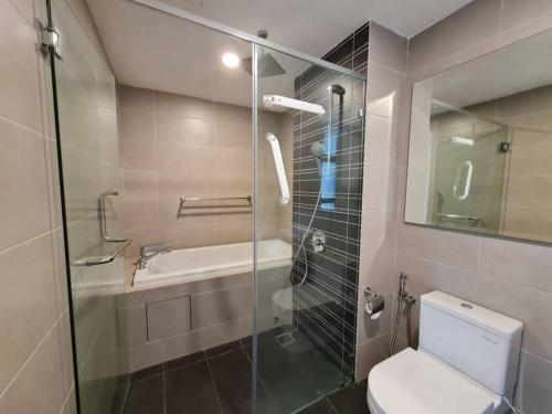 a bathroom with a shower and a toilet and a sink at 2 bedder Seaview condo with Wifi near Legoland for 6 pax in Nusajaya