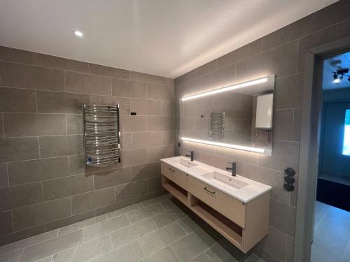 a bathroom with a sink and a mirror at Kåvan Townhouse Funäsdalen in Funäsdalen