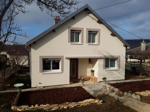 a white house with a yard at Maison Lombardi - Gite 6 Personnes 4 étoiles in Dun-sur-Meuse