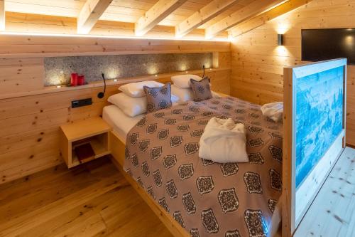 a bedroom with a bed in a wooden cabin at Madlhof in Himmelreich