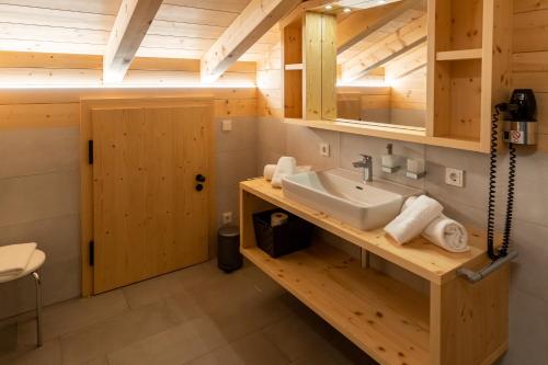 a bathroom with a sink in a wooden cabin at Madlhof in Himmelreich