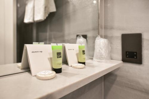 a bathroom counter with two boxes of soap and a mirror at Park Avenue Bayswater Inn Hyde Park in London