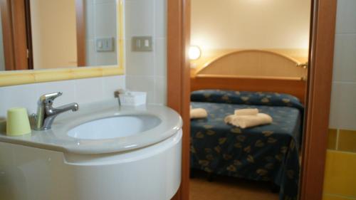 a bathroom with a sink and a mirror at Hotel Verudella in Rimini
