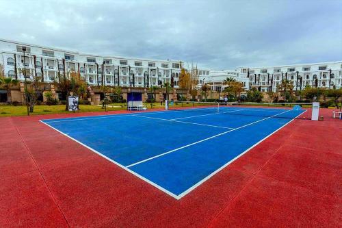 a tennis court in front of a large building at Marina Smir Hotel & Spa in M'diq