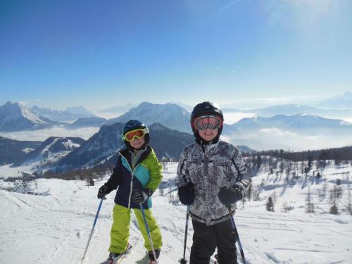 two people on skis on a snow covered slope at Bio-Urlaubshof Dansbach in Spital am Pyhrn