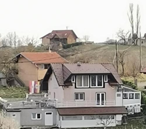 a house sitting on the side of a hill at Panorama Apartman in Molvice