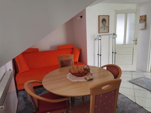 a living room with a table and a couch at Panorama Apartman in Molvice
