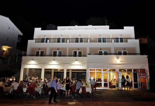 a group of people standing in front of a building at Villa Palloma in Baška Voda
