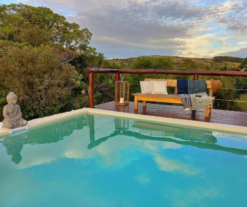 a bench sitting on a deck next to a swimming pool at Marrakech Villa Serrana in Villa Serrana