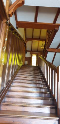 a flight of stairs in a building with a window at The Sleeping Bao B&B in Pietermaritzburg