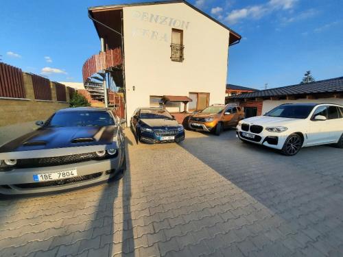 a group of cars parked in front of a building at Penzion Kera in Rossitz