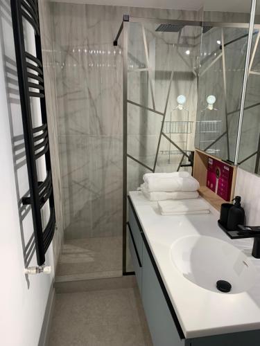 a bathroom with a sink and a shower at Prosper Plaza ApartHotel in Bucharest