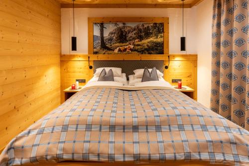 a bedroom with a large bed in a wooden room at Madlhof in Himmelreich