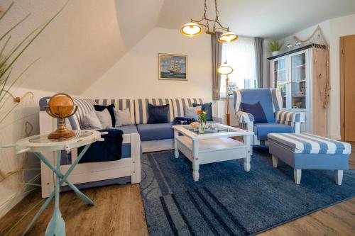 a living room with blue and white furniture at Traumzeit, FW 1 in Zingst