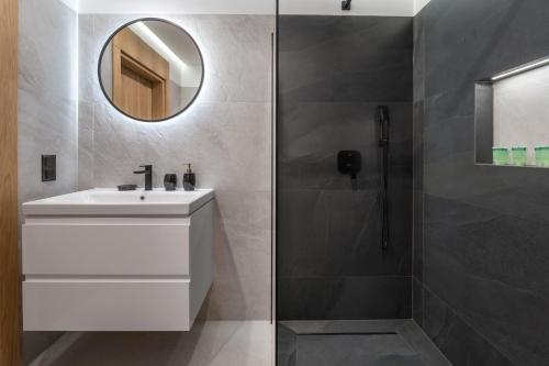 a bathroom with a white sink and a shower at Rezydencja Strążyska & Chalet BBQ in Zakopane