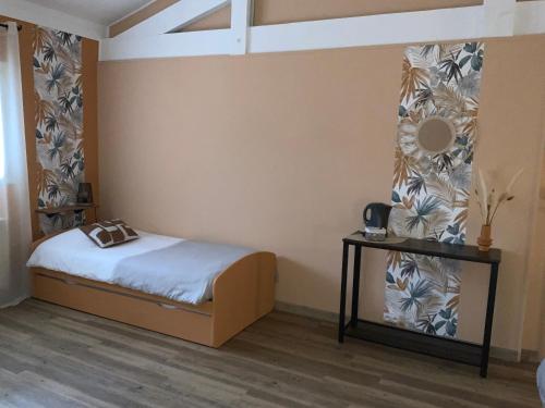 a bedroom with a bed and a table with a mirror at Domaine de Labelo in Commensacq