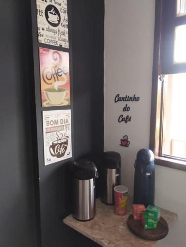 a counter with two trash cans and posters on a wall at POUSADA ARKAN BEACH in Saquarema