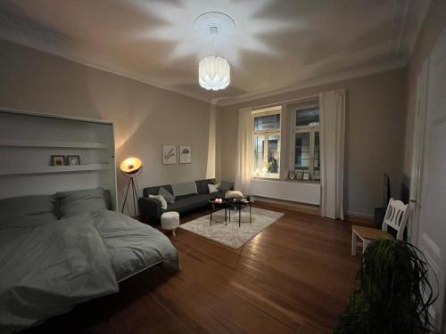 a bedroom with a bed and a living room at FeWo Taubenstern in Schwerin