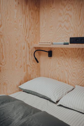 a bedroom with a bed with a shelf on the wall at Cabane Urbaine 3 - centre in Namur