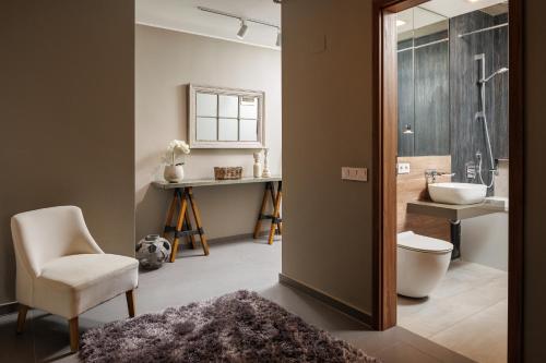 a bathroom with a sink and a toilet and a mirror at Cosmopolit Booking in Braşov