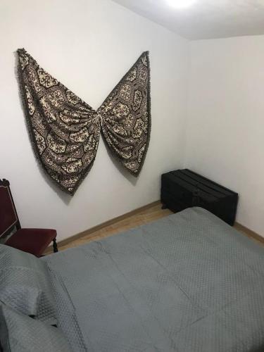 a bedroom with a bed and a butterfly on the wall at Casinha da Estrela in Arraiolos